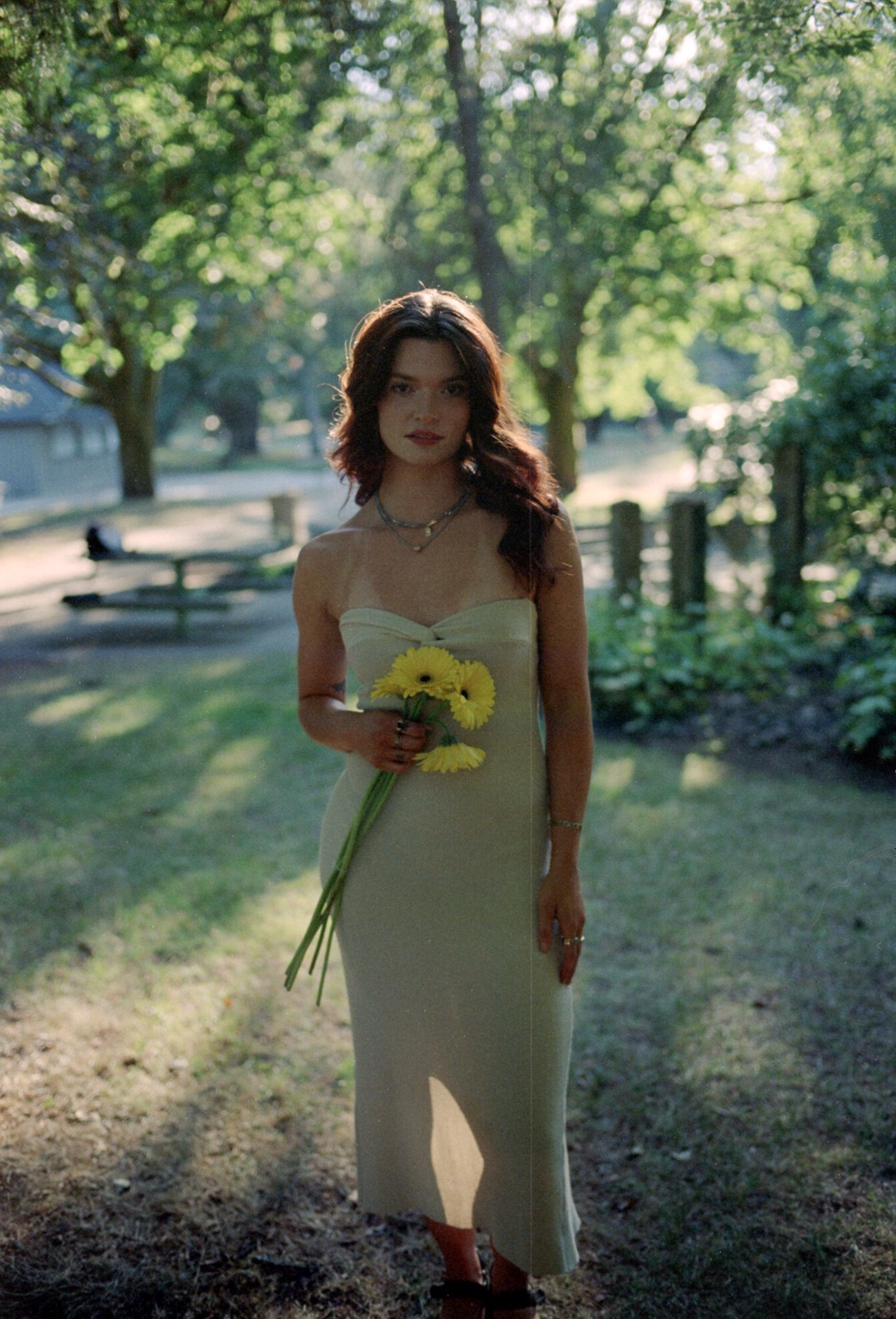 Sunlit outdoor portrait with yellow flowers